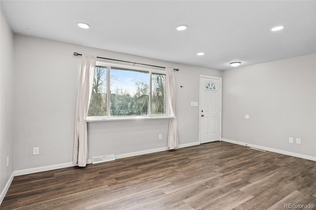 spare room featuring dark hardwood / wood-style flooring