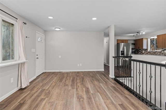 unfurnished room with sink and wood-type flooring