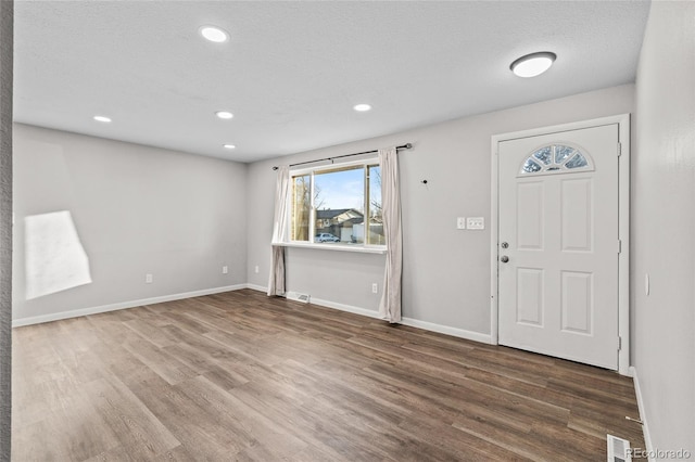 entrance foyer featuring wood-type flooring and a textured ceiling