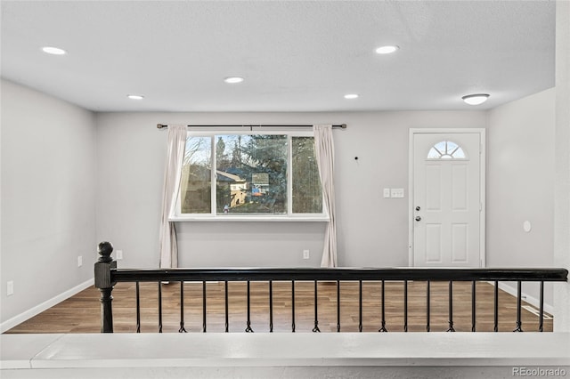 entrance foyer featuring wood-type flooring and a textured ceiling