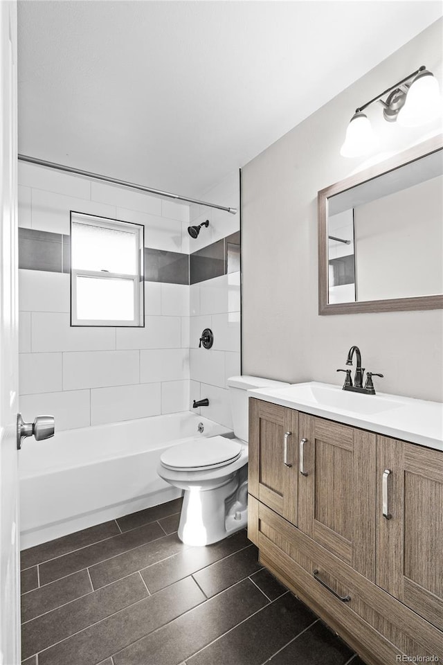 full bathroom featuring vanity, toilet, and tiled shower / bath combo