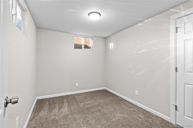 carpeted spare room with a textured ceiling