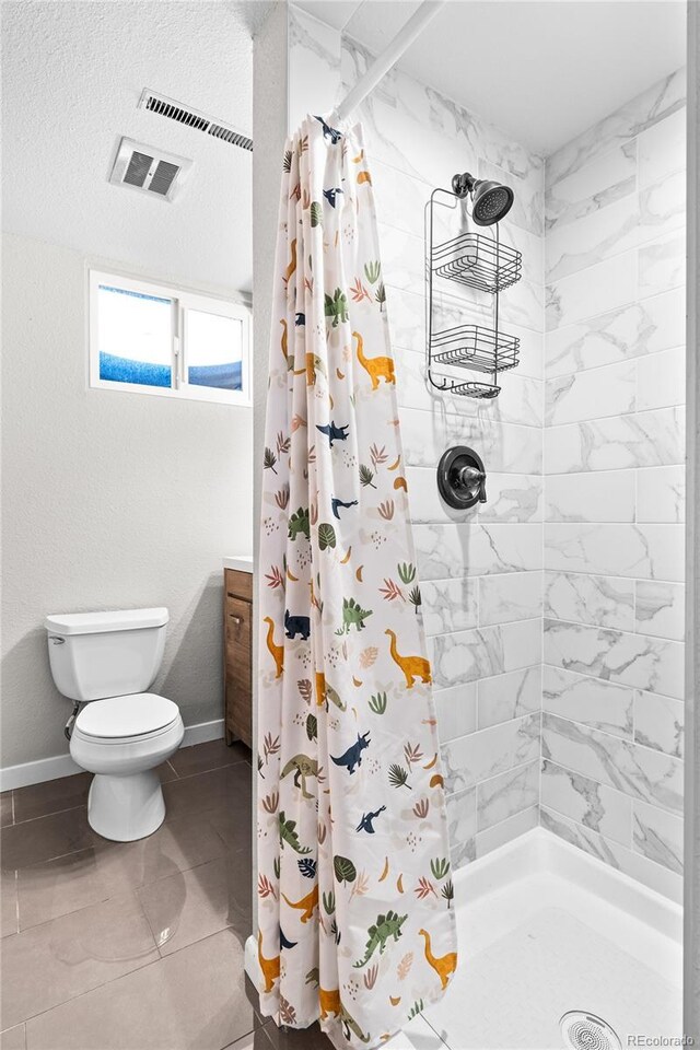 bathroom featuring vanity, toilet, and a shower with shower curtain