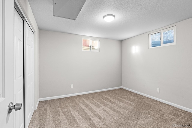 basement with carpet flooring and a textured ceiling