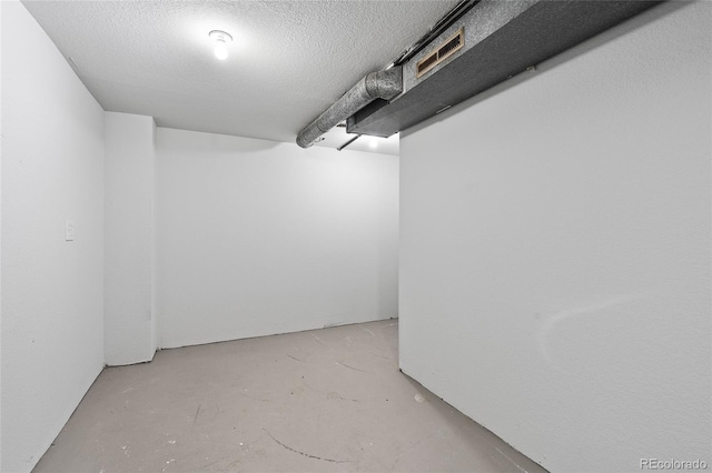 basement featuring a textured ceiling