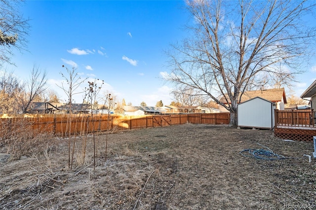 view of yard with a storage shed and a deck