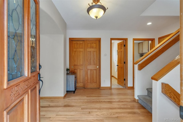 foyer with stairs, baseboards, recessed lighting, and light wood-style floors