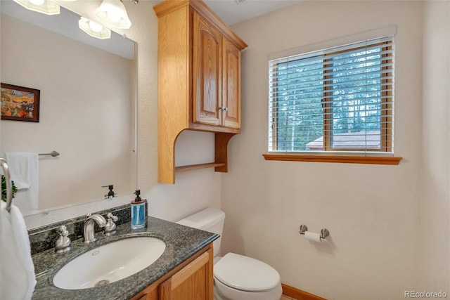 half bath featuring toilet and vanity
