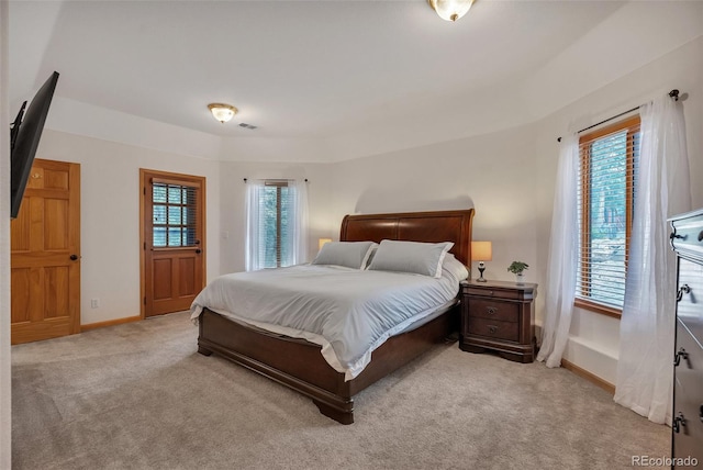 bedroom with light colored carpet, baseboards, and visible vents