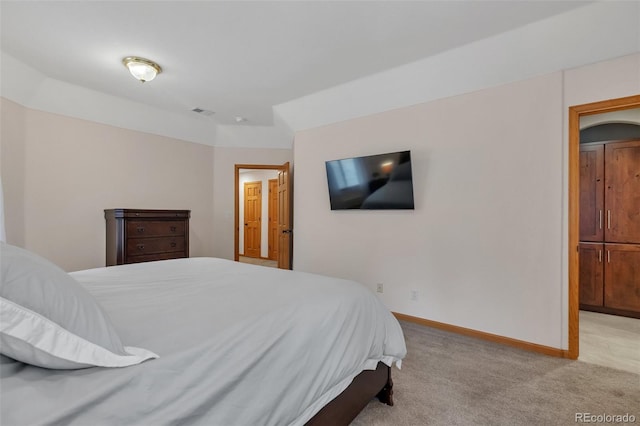 bedroom featuring visible vents, baseboards, and light colored carpet
