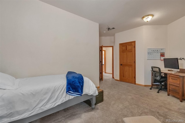bedroom featuring baseboards, visible vents, and light colored carpet