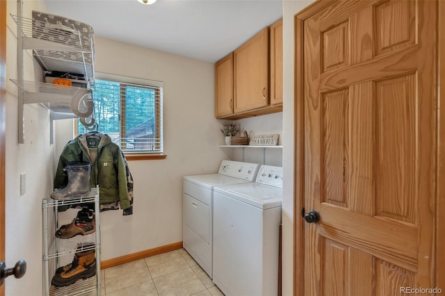 washroom with baseboards, cabinet space, light tile patterned flooring, and independent washer and dryer
