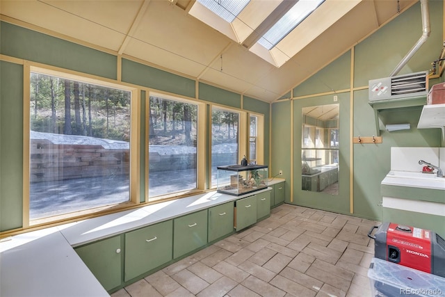 sunroom featuring a skylight, a sink, and a wealth of natural light