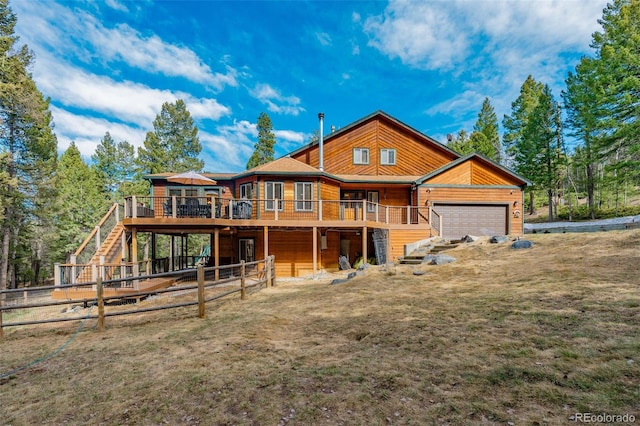 view of front of property with log veneer siding, fence, a wooden deck, a garage, and stairway