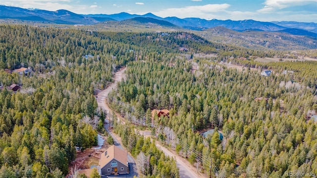 bird's eye view with a mountain view and a view of trees