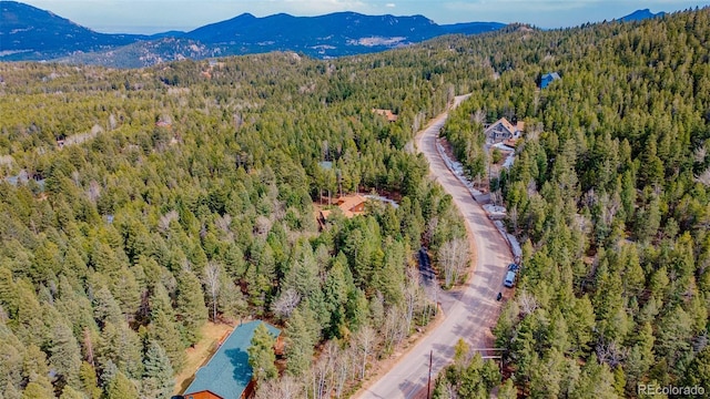 aerial view featuring a mountain view and a view of trees