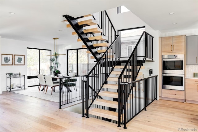 stairway with hardwood / wood-style floors