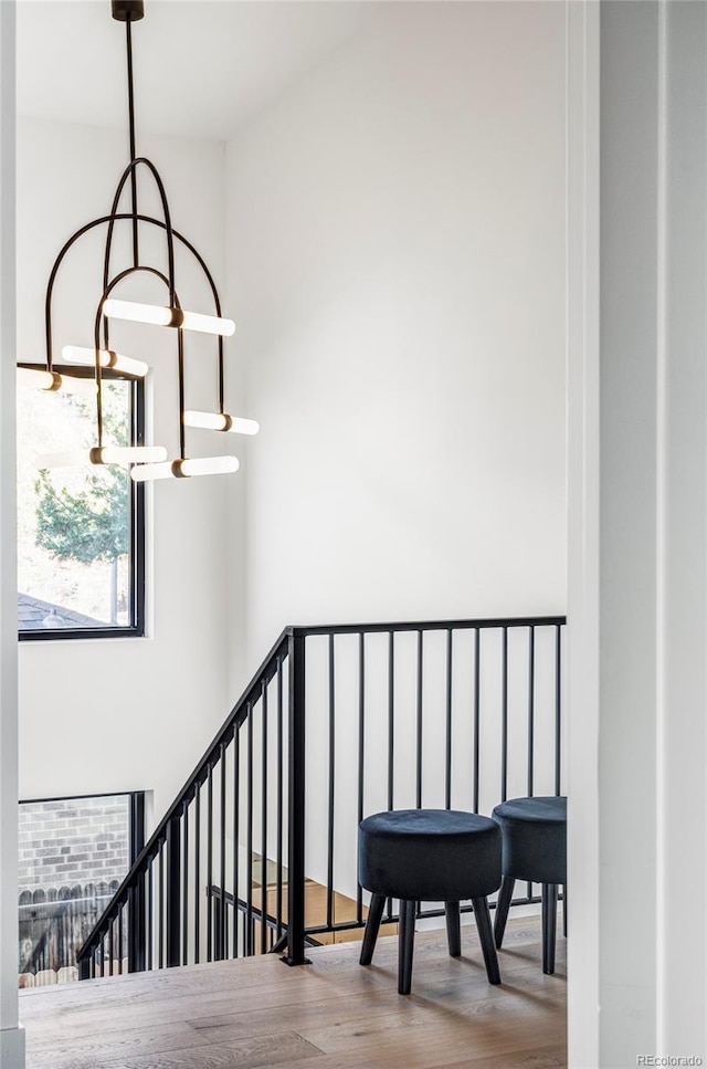 stairway featuring a chandelier and hardwood / wood-style flooring