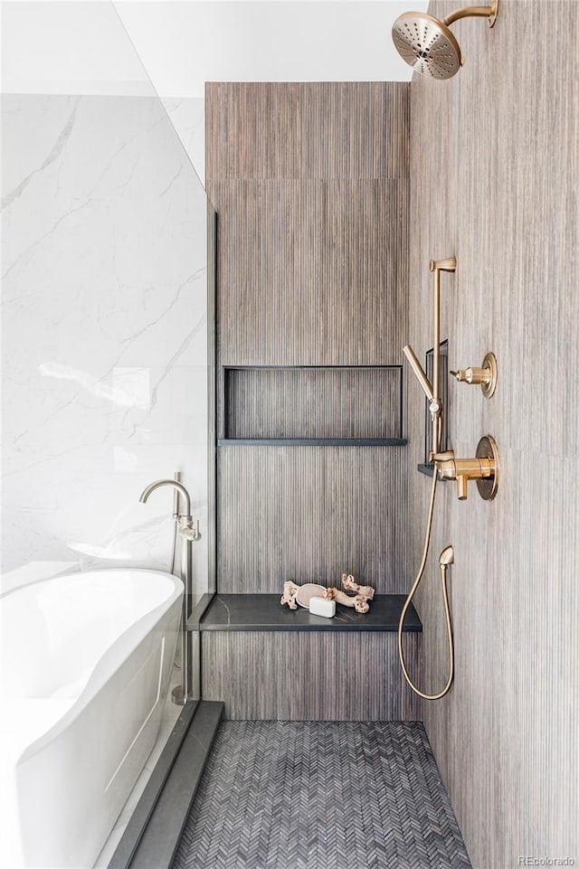 bathroom featuring separate shower and tub and tile walls