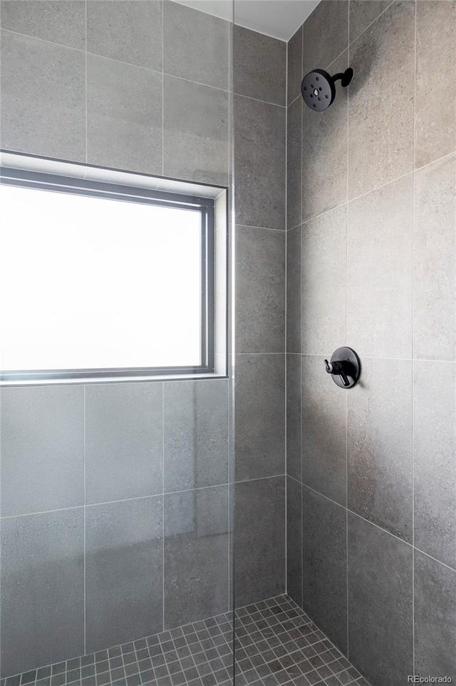 bathroom with tiled shower