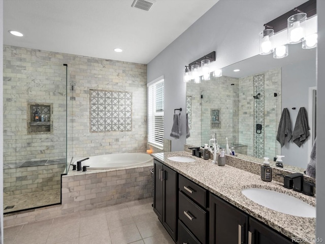 bathroom with a shower stall, tile patterned flooring, visible vents, and a sink
