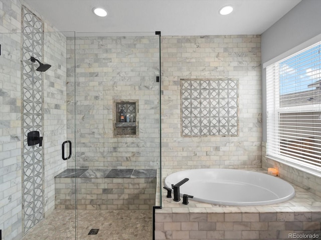 bathroom featuring recessed lighting, a stall shower, and a garden tub