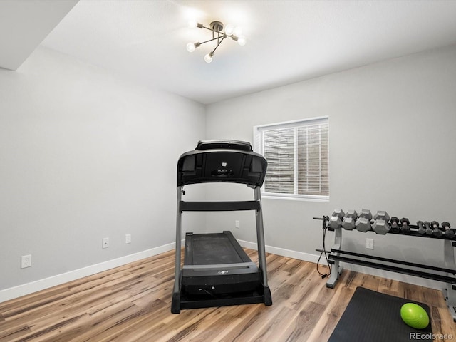 exercise area featuring wood finished floors and baseboards