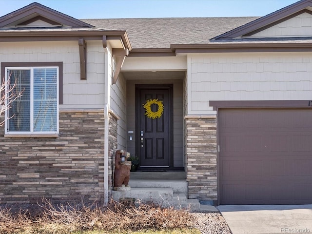 doorway to property featuring a garage, roof with shingles, and stone siding