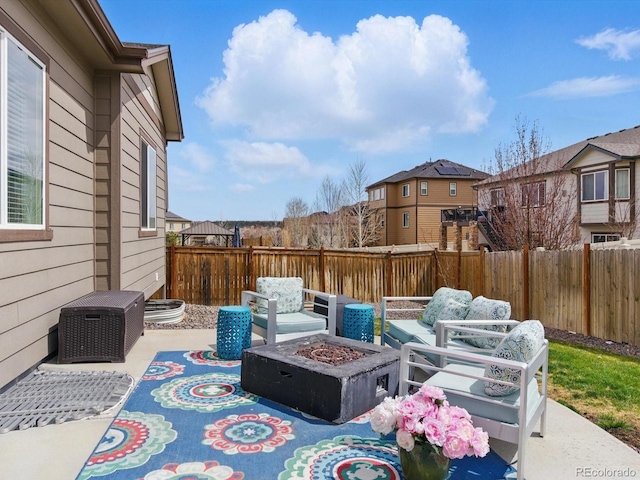 view of patio featuring an outdoor fire pit and fence