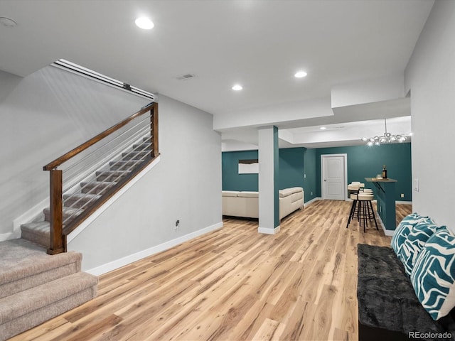 living area featuring wood finished floors, recessed lighting, visible vents, and stairs