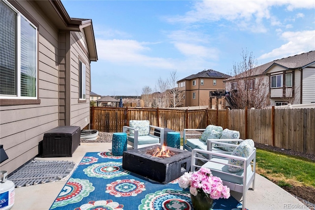 view of patio with an outdoor fire pit and fence
