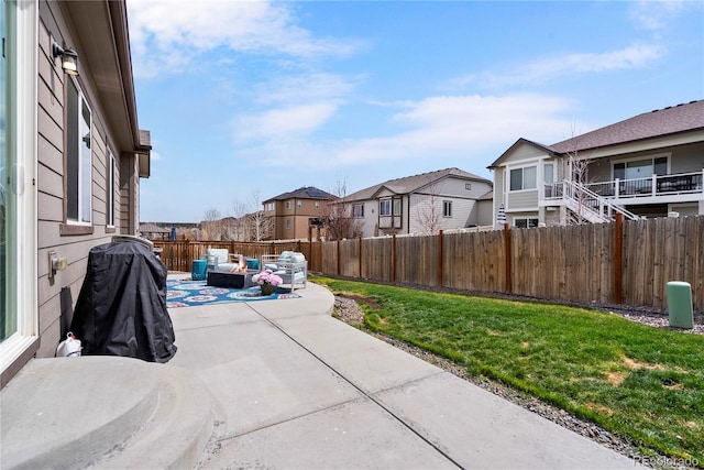 view of patio / terrace featuring outdoor lounge area, a fenced backyard, and a residential view
