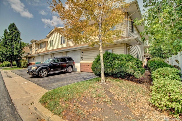 view of front of home with a garage and brick siding