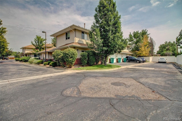 view of front of home featuring fence