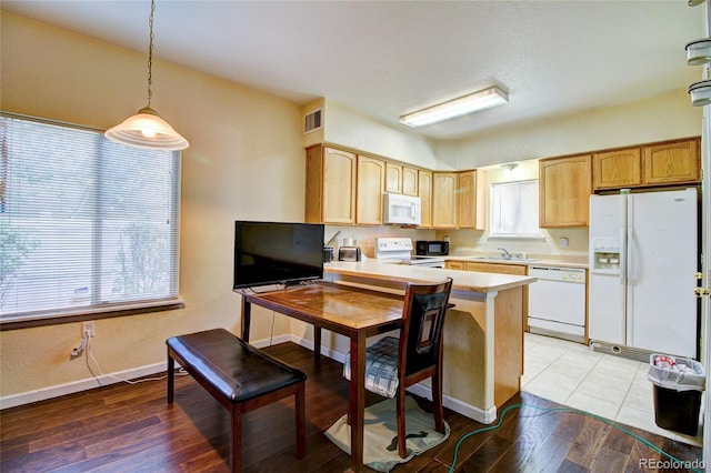 kitchen featuring visible vents, light wood-style flooring, white appliances, a peninsula, and light countertops