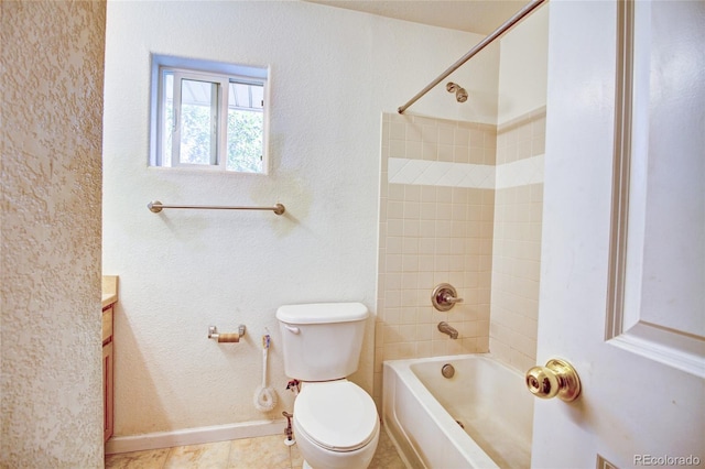 bathroom with toilet, tub / shower combination, baseboards, and a textured wall