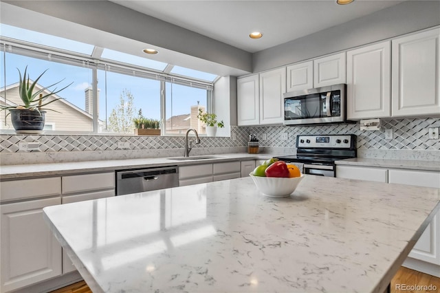 12551 W 84th Cir, Arvada, CO 80005 - kitchen with appliances with stainless steel finishes, decorative backsplash, and a sink