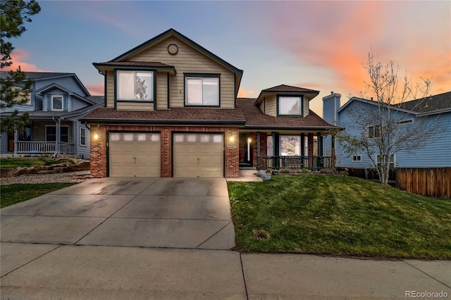 12551 W 84th Cir, Arvada, CO 80005 - traditional home featuring fence, driveway, covered porch, a lawn, and a garage