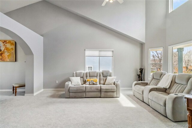 12551 W 84th Cir, Arvada, CO 80005 - living room with carpet, arched walkways, baseboards, high vaulted ceiling, and ceiling fan