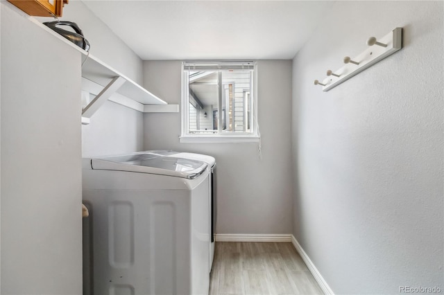 12551 W 84th Cir, Arvada, CO 80005 - clothes washing area featuring washing machine and dryer, baseboards, wood finished floors, and laundry area