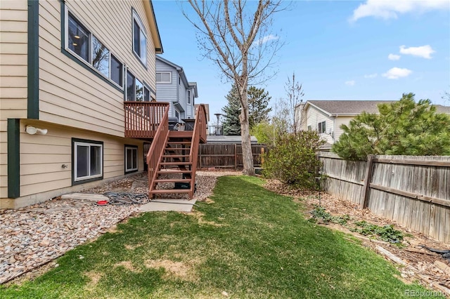 12551 W 84th Cir, Arvada, CO 80005 - view of yard with a fenced backyard, a wooden deck, and stairway