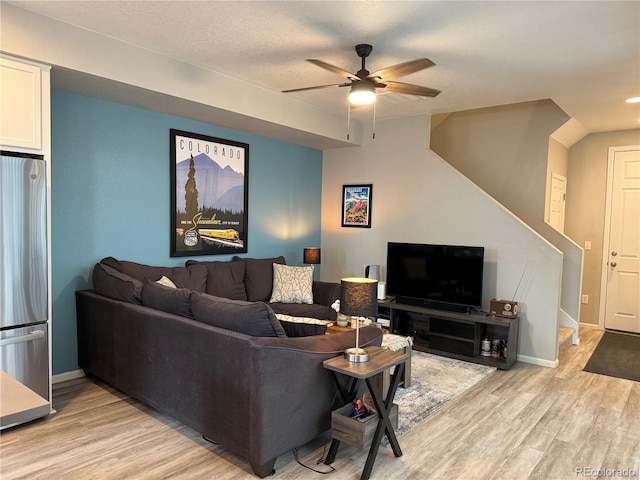 living room featuring ceiling fan and light wood-type flooring