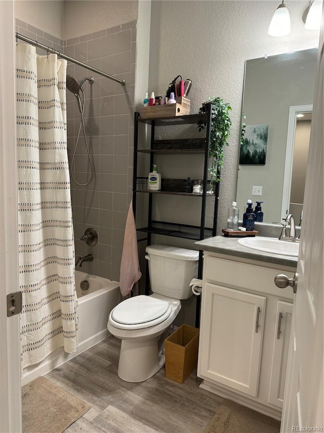 full bathroom featuring vanity, shower / bathtub combination with curtain, wood-type flooring, and toilet