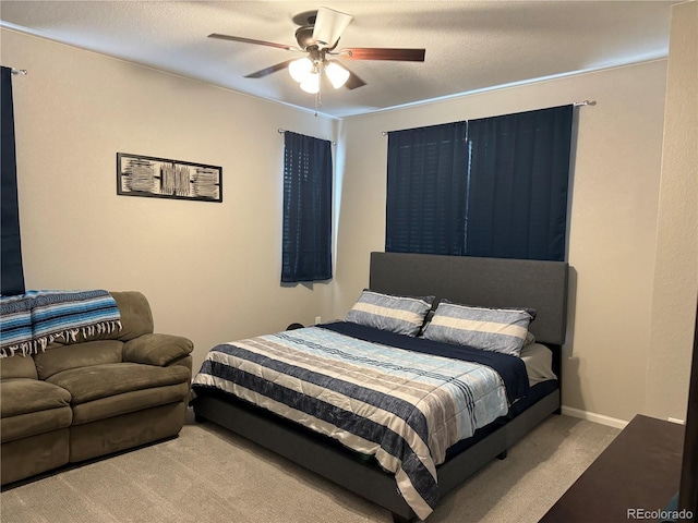 bedroom with light carpet, a textured ceiling, and ceiling fan