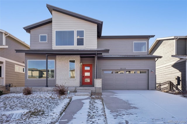 view of front facade featuring a garage, concrete driveway, and brick siding