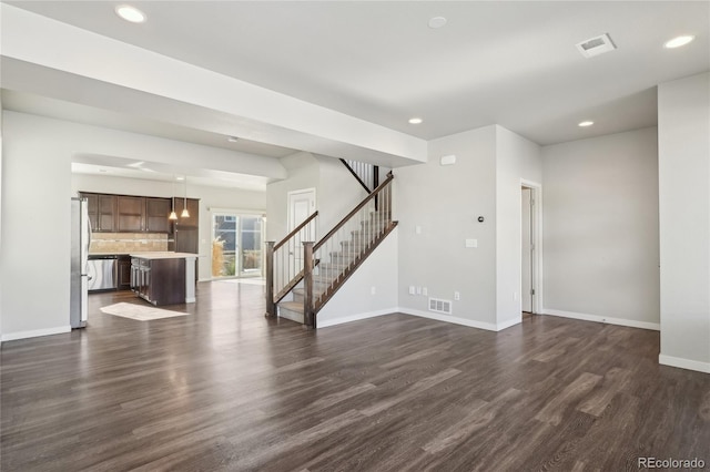 unfurnished living room featuring recessed lighting, visible vents, baseboards, stairs, and dark wood-style floors