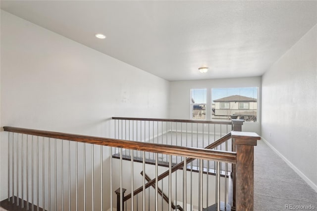 stairs with carpet floors and baseboards