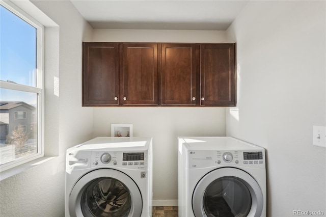 washroom with washer and dryer and cabinet space