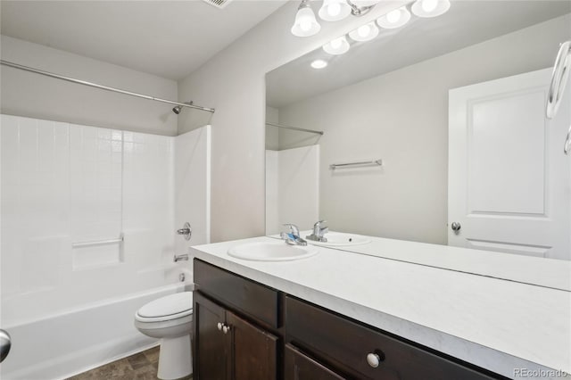 bathroom featuring vanity, toilet, and shower / bathtub combination