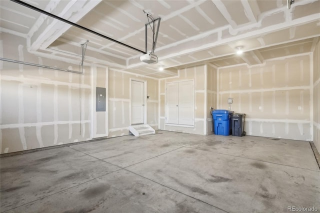 garage with electric panel and a garage door opener